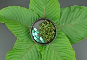 Thumbnail-For-Kratom-Capsules-Over-Leaves-By-King K. Kratom